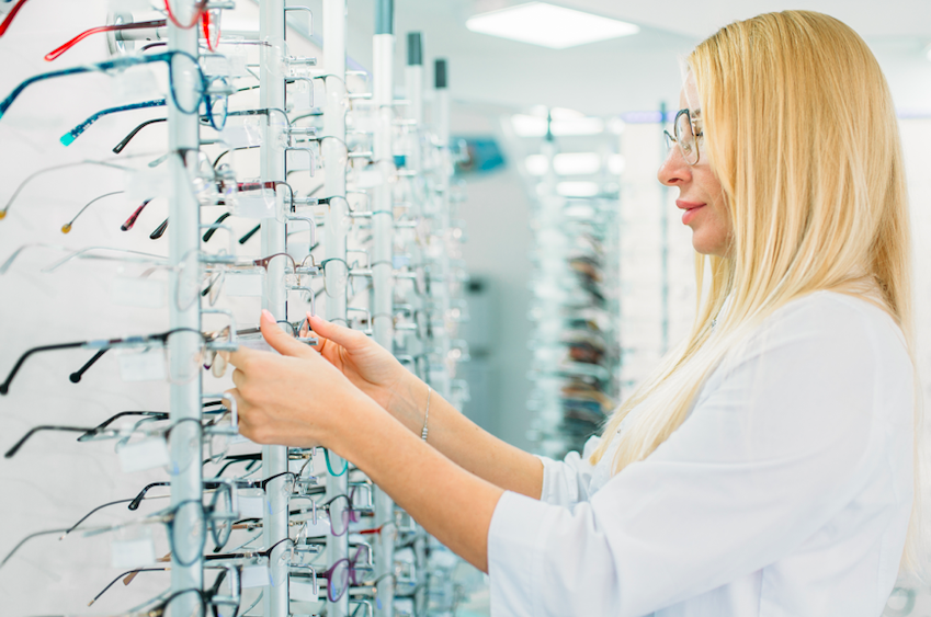 A woman checking out spectacles from the shop